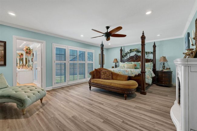 Bedroom with recessed lighting, light wood finished floors, ornamental molding, baseboards, and a ceiling fan | Image 22