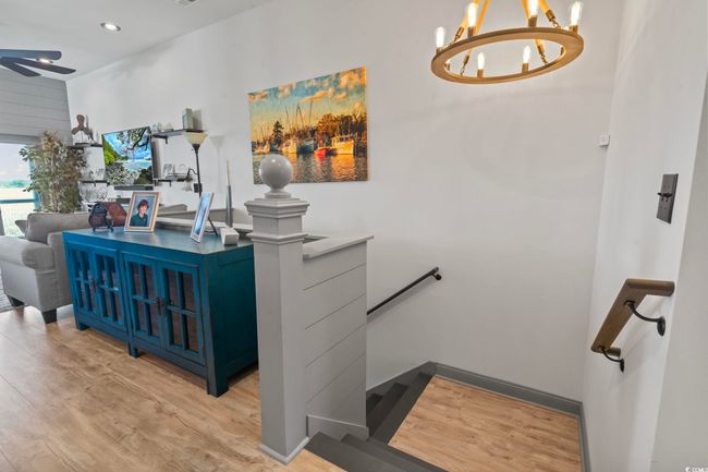 Staircase with ceiling fan with notable chandelier, wood finished floors, and recessed lighting | Image 25