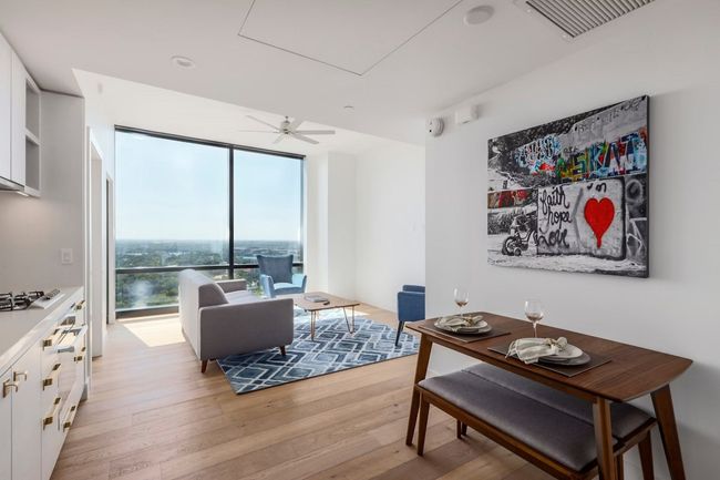 Living room featuring light wood-style flooring, visible vents, and ceiling fan | Image 6