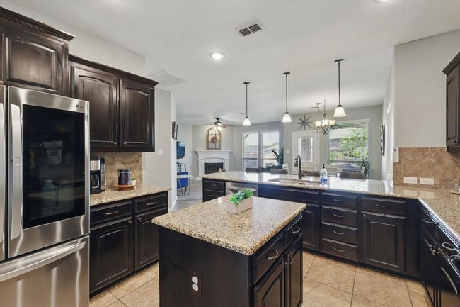 Kitchen with stainless steel appliances, tasteful backsplash, visible vents, and a sink | Image 7