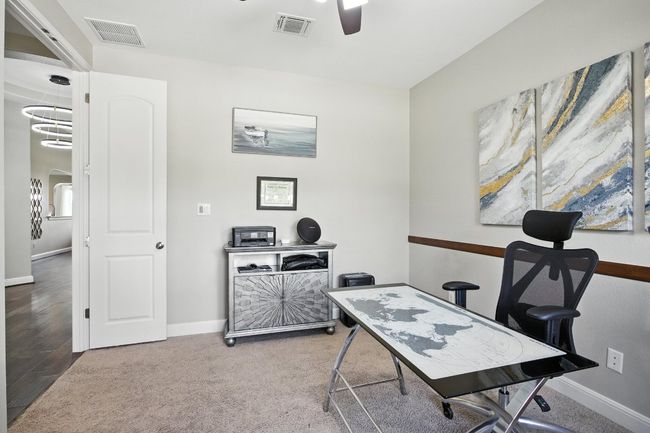 Office space with ceiling fan and baseboards | Image 12