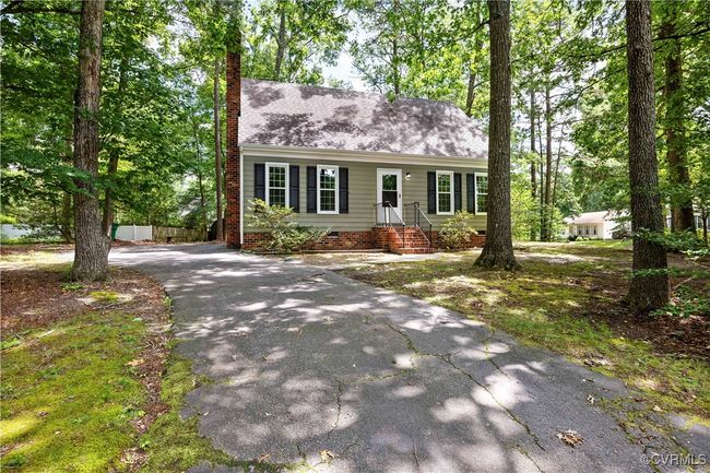 View of front of house with a chimney, asphalt driveway, a shingled roof, and crawl space | Image 25