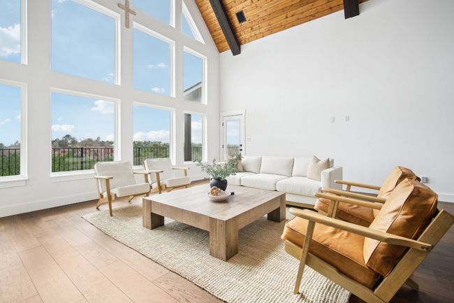 Living area with a wooden ceiling with exposed beams, high vaulted ceiling, and hardwood / wood-style floors | Image 8
