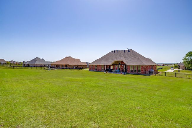 Rear view of house featuring a yard, fence, and brick siding | Image 33