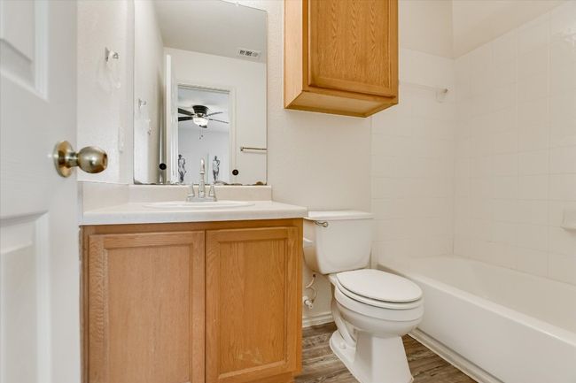 Bathroom featuring vanity, wood finished floors, and washtub / shower combination | Image 20