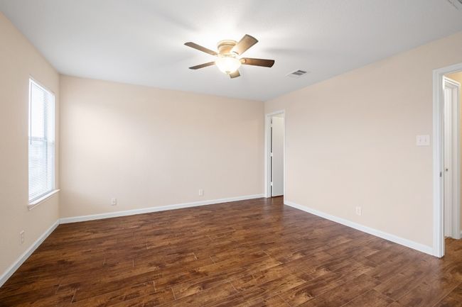 Spare room featuring ceiling fan and dark wood finished floors | Image 24