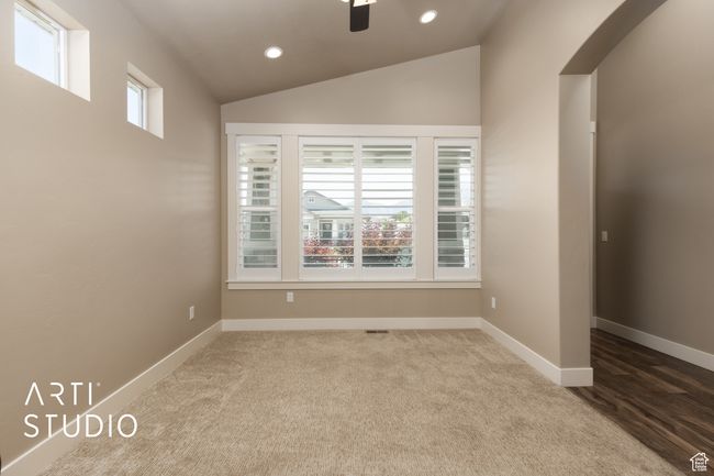 Carpeted spare room featuring recessed lighting, vaulted ceiling, arched walkways, and ceiling fan | Image 8