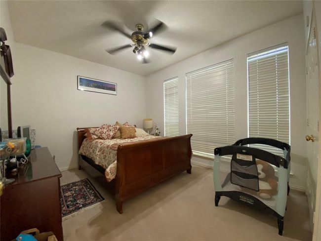 Carpeted bedroom featuring ceiling fan | Image 24