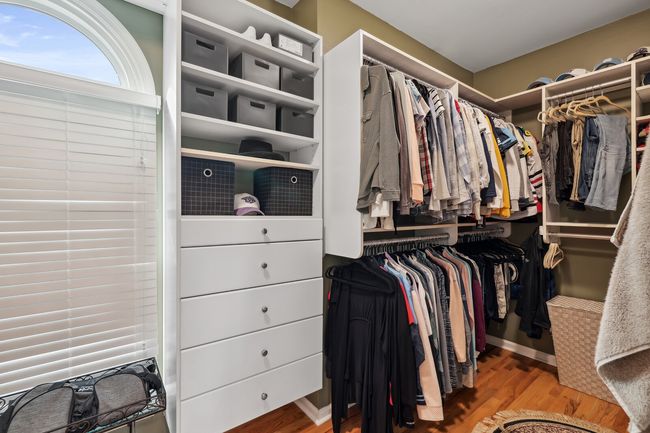 Primary closet has plenty of room, courtesy of the built in storage drawers and shelving! | Image 25