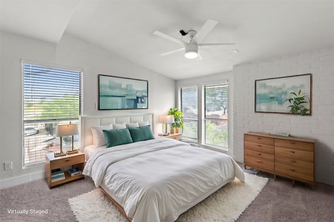 Carpeted bedroom with vaulted ceiling and ceiling fan | Image 6