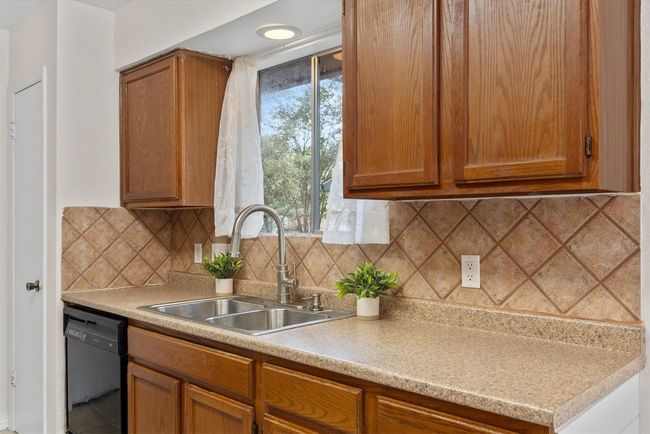 From the stainless steel appliances to the spacious design, this kitchen offers everything you need for seamless cooking and storage | Image 9