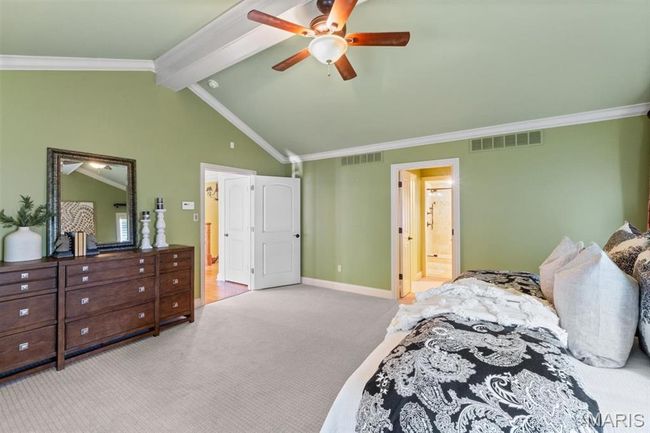 Bedroom featuring carpet floors, connected bathroom, ornamental molding, and a ceiling fan | Image 43