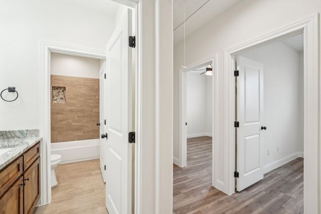 Full bathroom featuring visible vents, toilet, shower / bathing tub combination, and vanity | Image 28