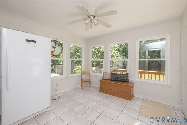 Sunroom / solarium with tile patterned floors and ornamental molding | Image 16