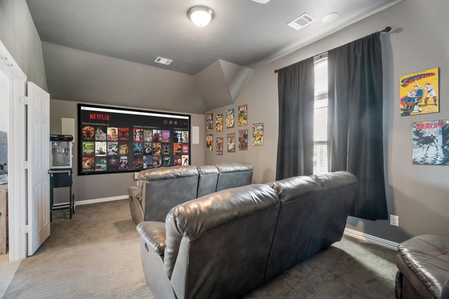 Carpeted cinema featuring vaulted ceiling and baseboards | Image 26