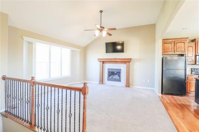 Living room with lofted ceiling, light hardwood / wood-style flooring, and ceiling fan | Image 2