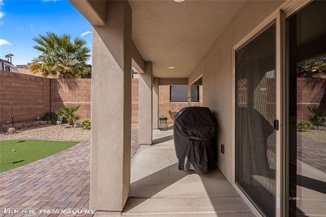 View of patio / terrace with a fenced backyard and a putting green | Image 46