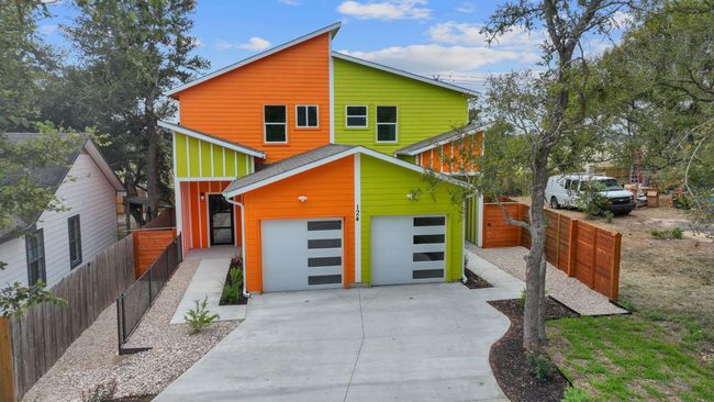 Contemporary home with concrete driveway and fence | Image 8