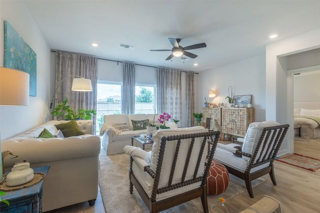 Living room featuring a ceiling fan, light wood-style flooring, and recessed lighting | Image 6