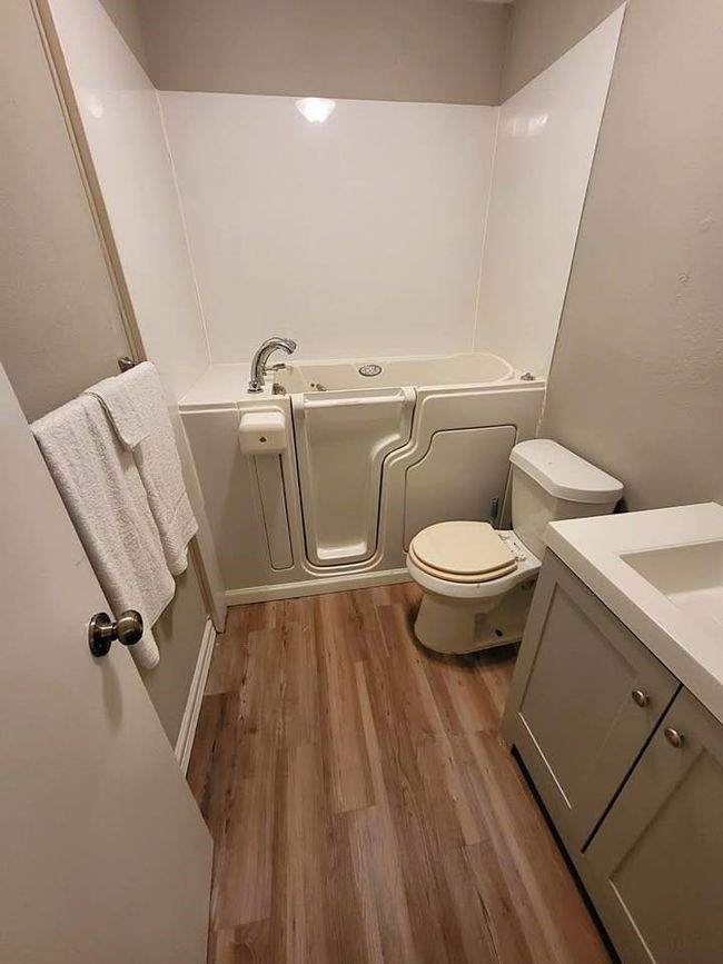Primary bathroom with walk-in bathtub & sit down shower | Image 10