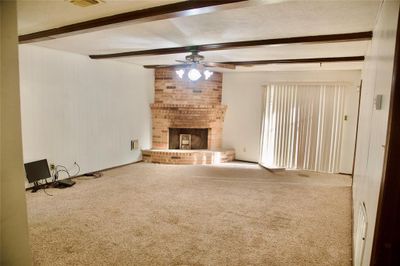 Living room with fireplace and beautiful wood beams | Image 3