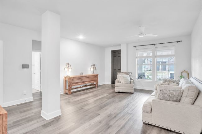 Living room with ceiling fan and light wood-type flooring | Image 5