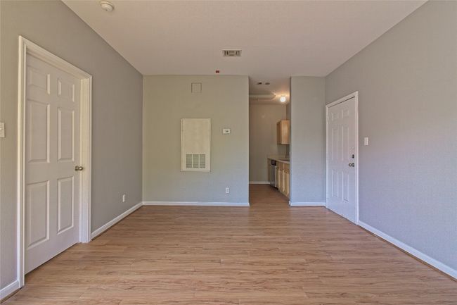 Unfurnished room featuring light wood-style flooring and a smoke detector | Image 16