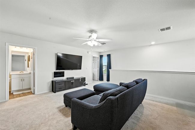 Living area with light carpet and ceiling fan | Image 18