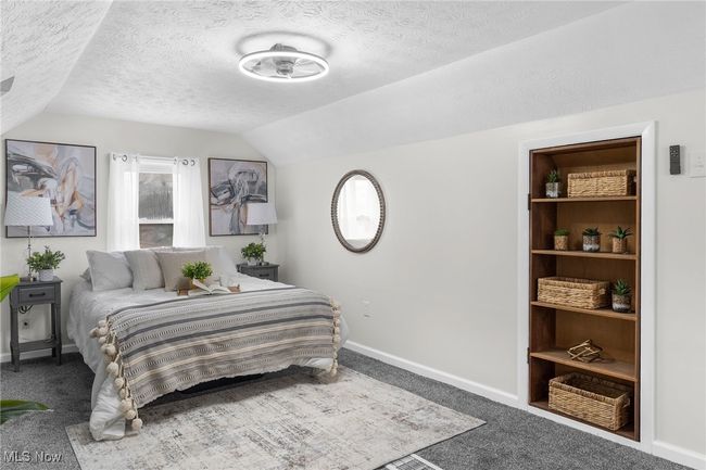 Bedroom with vaulted ceiling, a textured ceiling, and carpet | Image 10