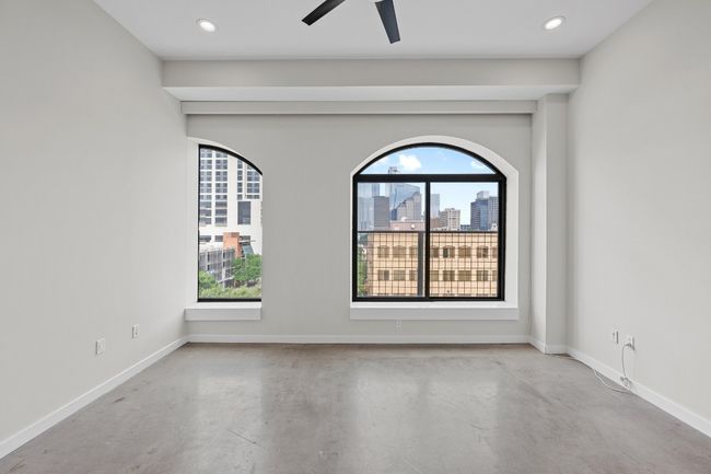 Spare room with finished concrete floors, recessed lighting, baseboards, and plenty of natural light | Image 12