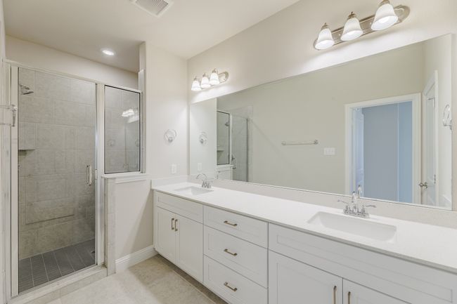 Full bathroom with tile patterned floors, a stall shower, and double vanity | Image 19