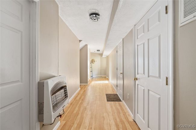 Hallway to basement with storage closets | Image 34