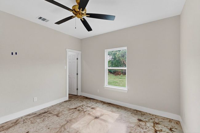 Empty room with ceiling fan and baseboards | Image 39
