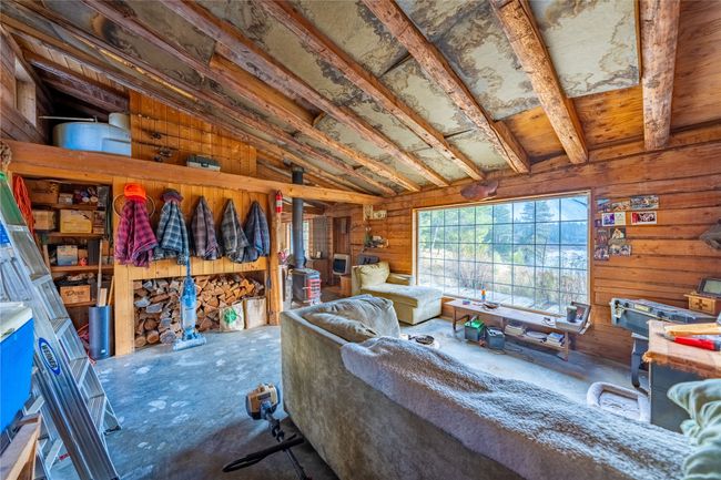 Living room with wooden walls and vaulted ceiling | Image 22