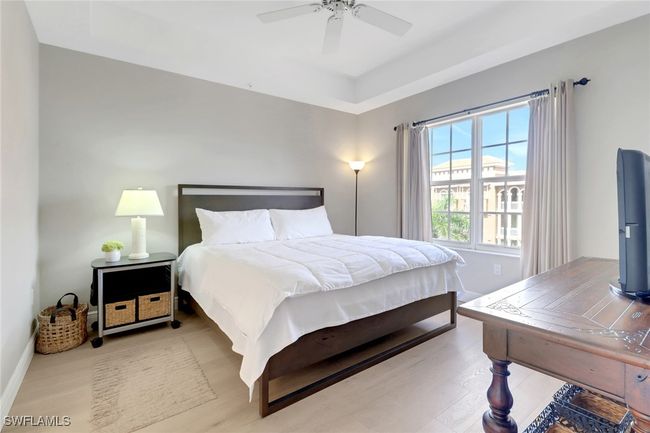 Bedroom with wood finished floors and a ceiling fan | Image 7