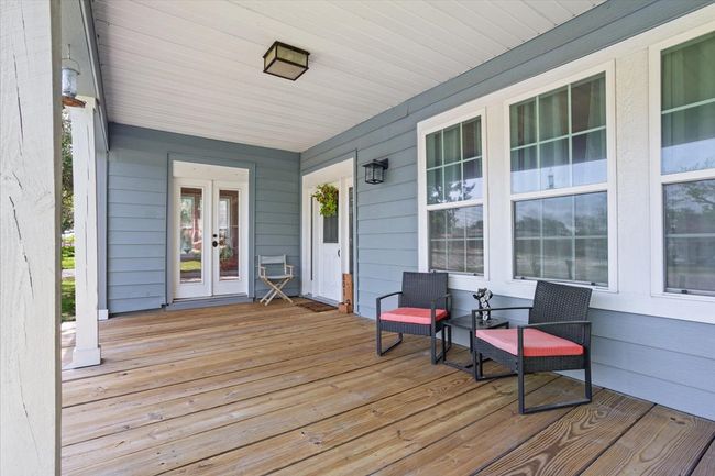 Wooden deck featuring french doors and covered porch | Image 4