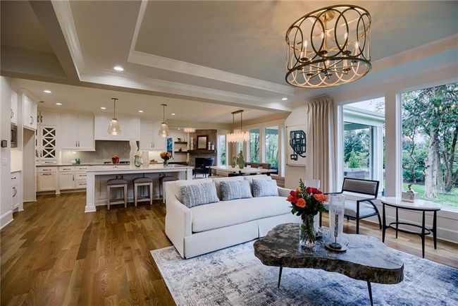 Living room with hardwood / wood-style floors, plenty of natural light, and an inviting chandelier | Image 8