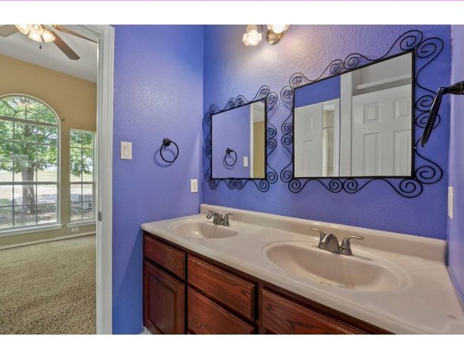 Bathroom featuring a textured wall and double vanity | Image 24