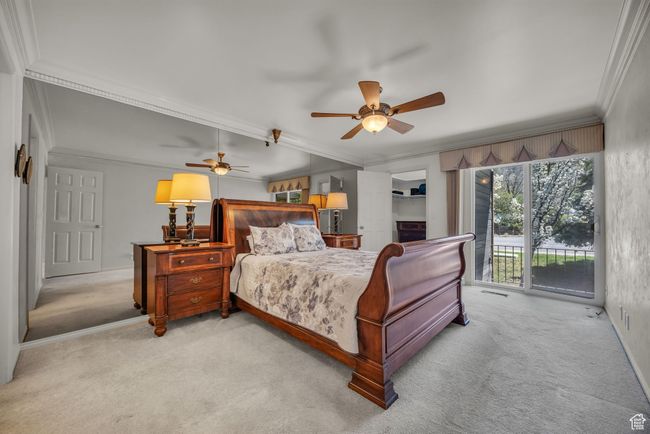 Carpeted bedroom with crown molding, access to exterior, ceiling fan, and visible vents | Image 6