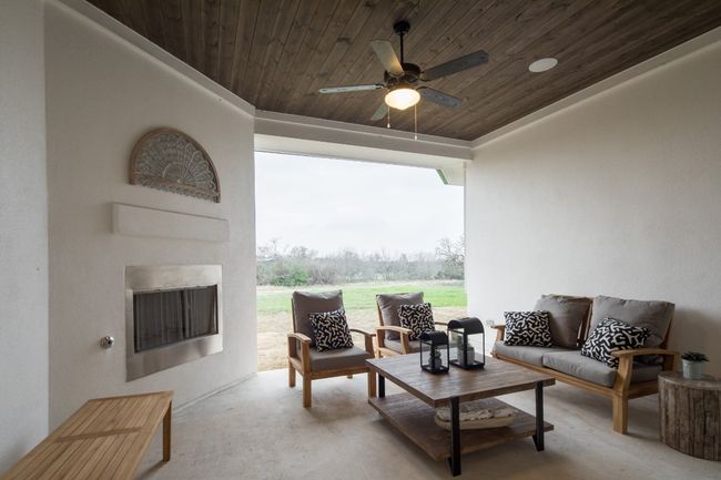 View of patio featuring an outdoor living space with a fireplace and a ceiling fan | Image 26