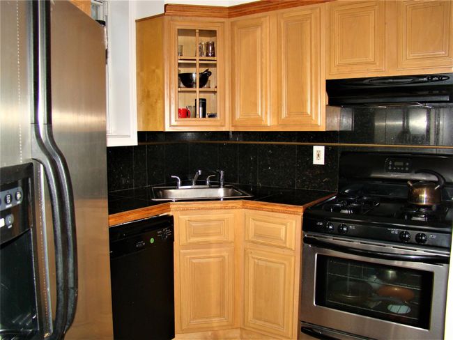 Kitchen with sink, backsplash, and stainless steel appliances | Image 4