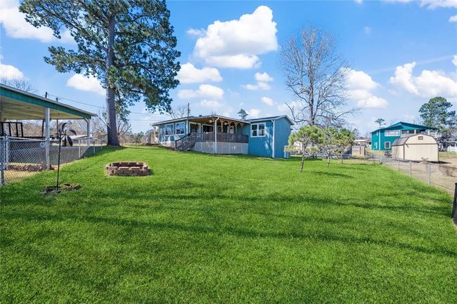 Back yard is fenced. This photo is taken from the corner with the boat house. | Image 23