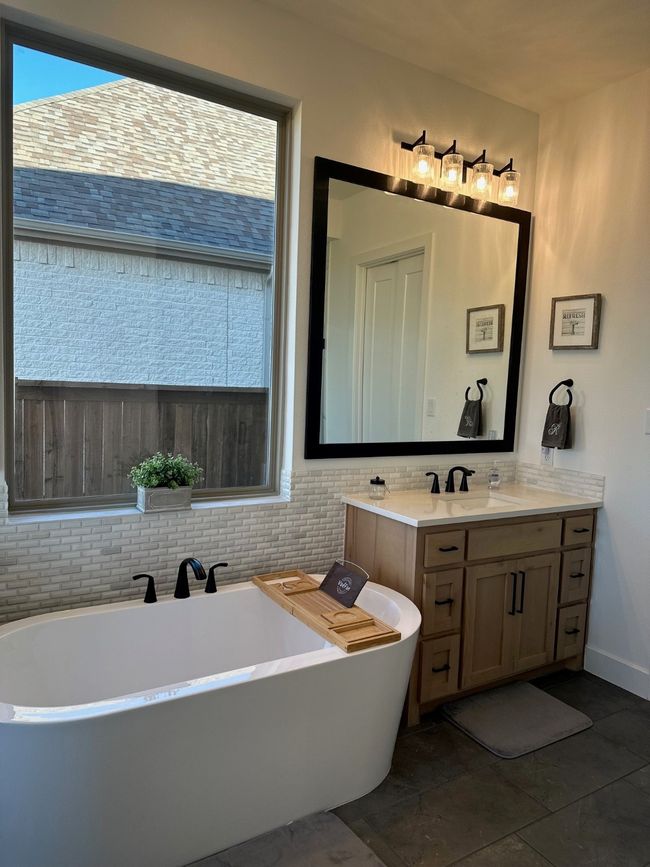 Bathroom featuring a soaking tub and vanity | Image 22