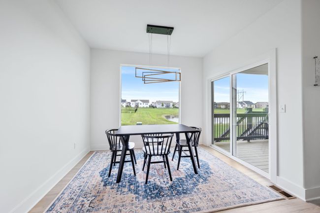 Dining room with wood finished floors and baseboards | Image 14
