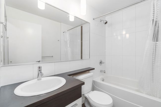 Bathroom with vanity, tasteful backsplash, shower / bath combination with curtain, and toilet | Image 32