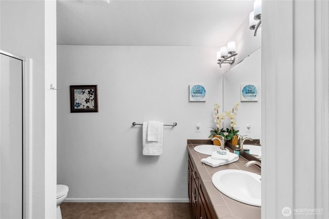 Private bath off primary suite with dual vanity and large walk in shower. | Image 12