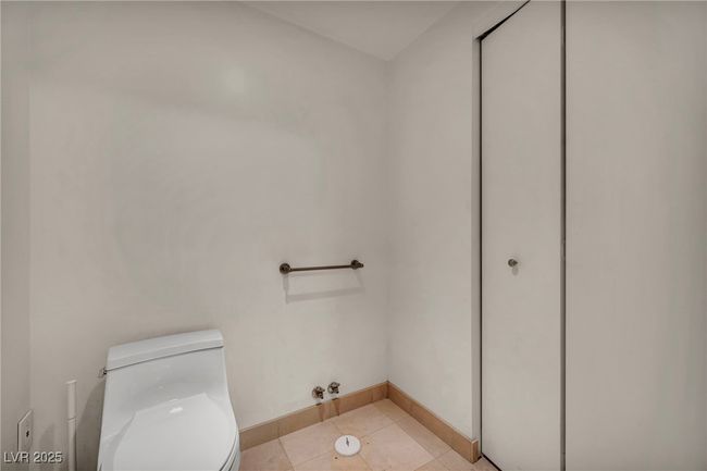 Bathroom featuring toilet, tile patterned flooring, and baseboards | Image 37