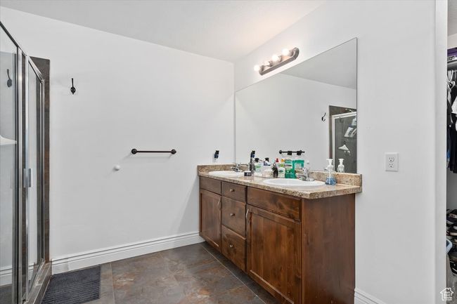 Bathroom featuring a shower with shower door and vanity | Image 19