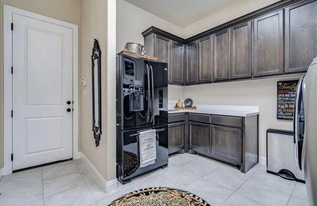 Entrance to three car garage and mud room area with additional refrigerator space | Image 11