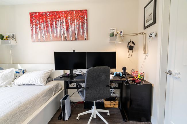 Bedroom with wood finished floors | Image 11